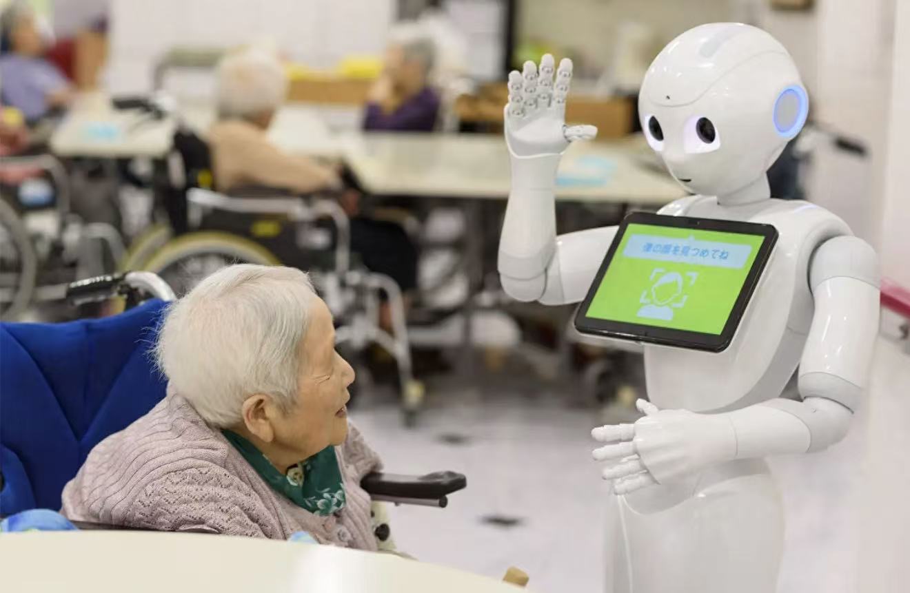 Photo of senior interacting with intelligent companion robot in care setting